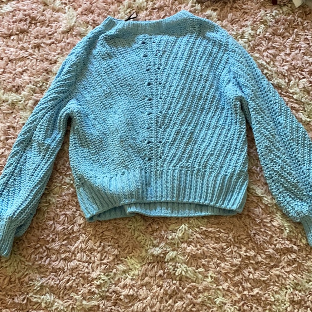 Baby blue sweater.knitting throughout the sweater
